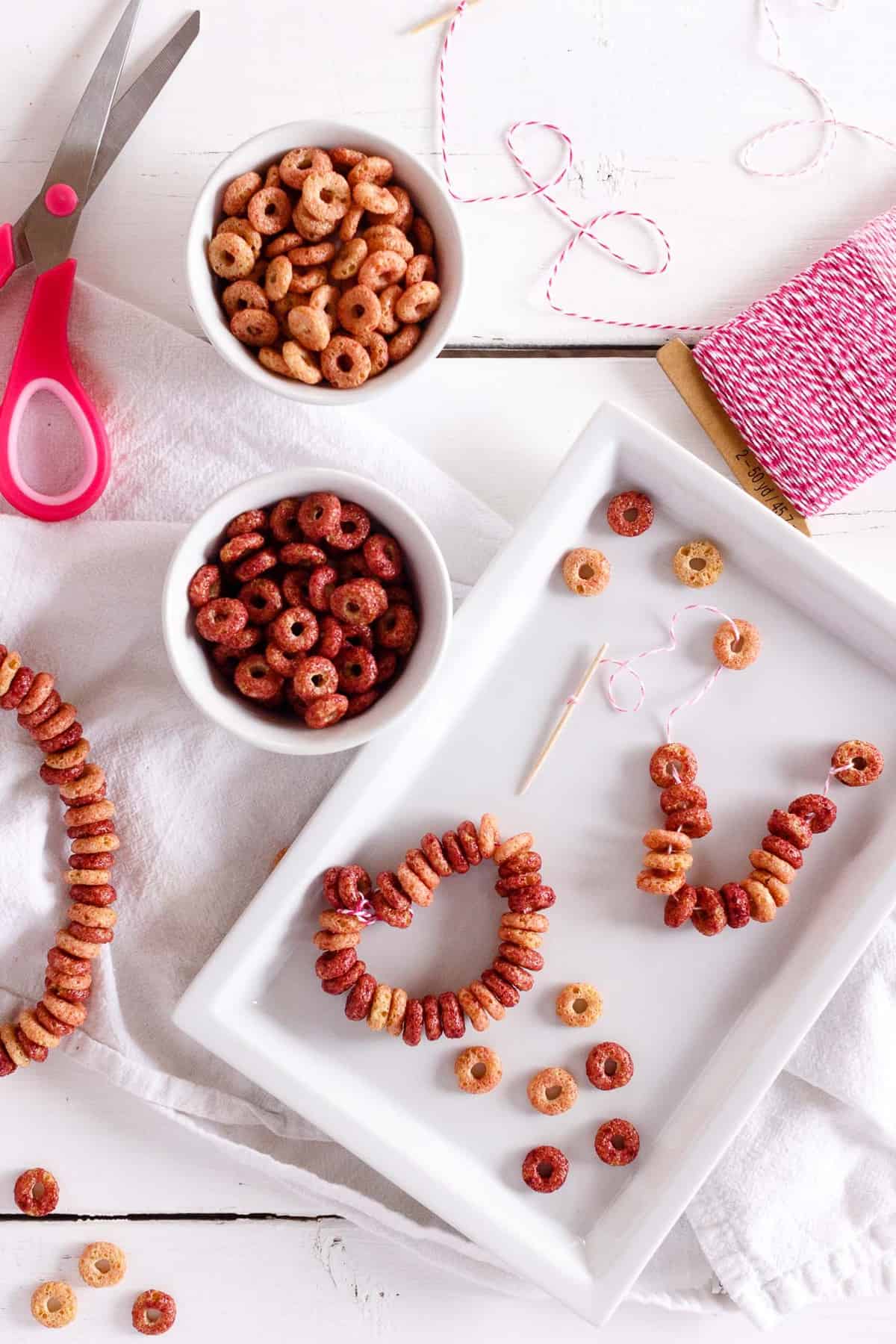 Overhead shot of cereal bracelets and necklaces using Nature's Path Organic's Envirokidz Cheetah Chomps Cereal.