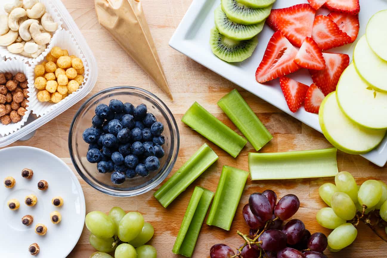 Cut fruit and vegetables prepared for making fruit bug snacks.