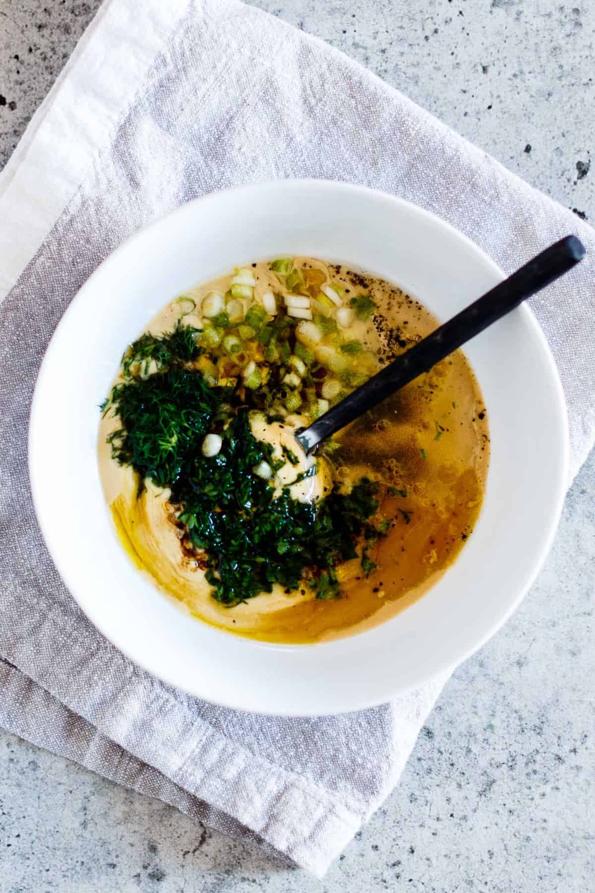 Ingredients for Vegan Tahini Goddess Dressing in a white bowl